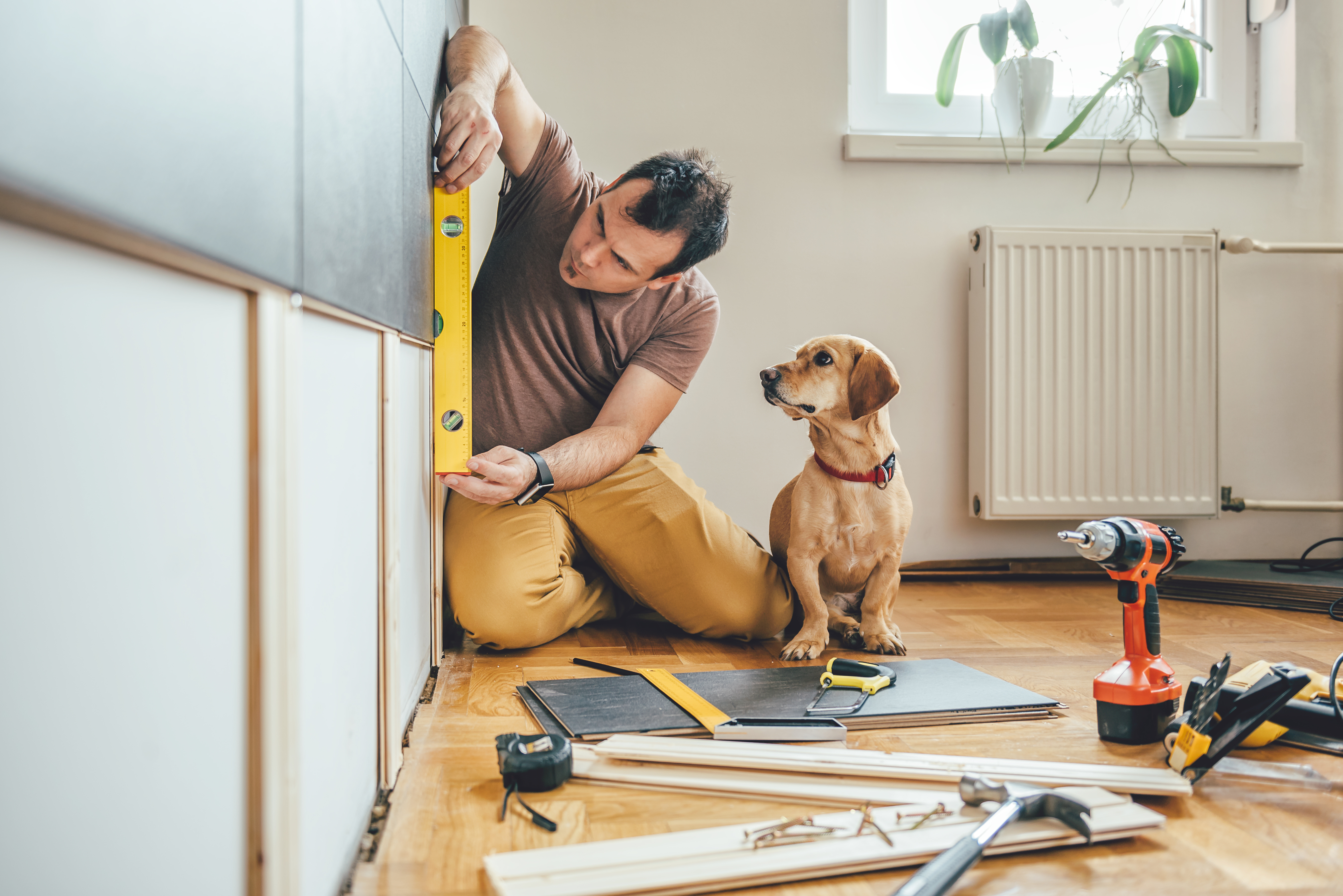 Man completing a home renovation project thanks to a home improvement loan.