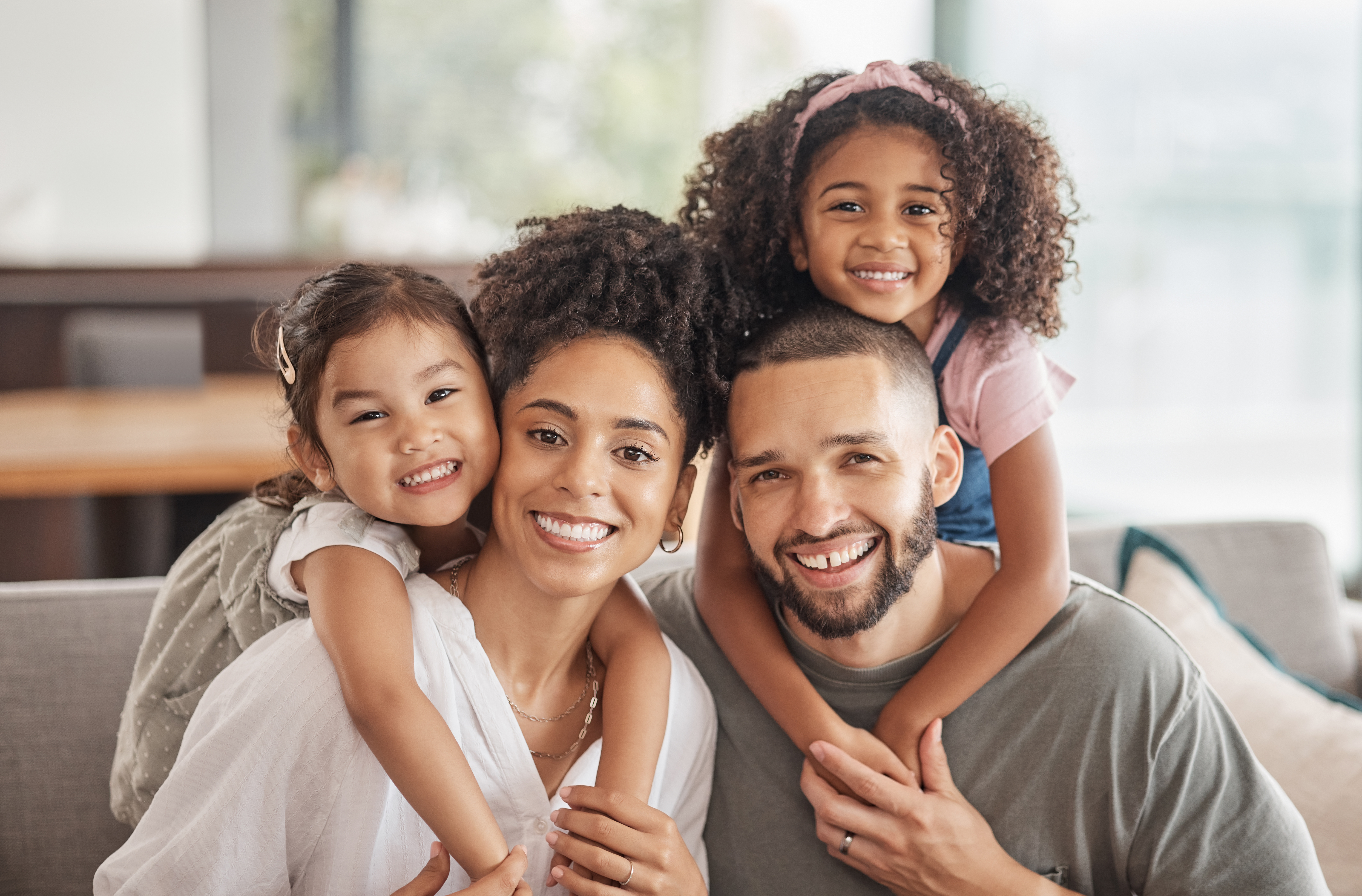 A smiling family in the sitting room of their home