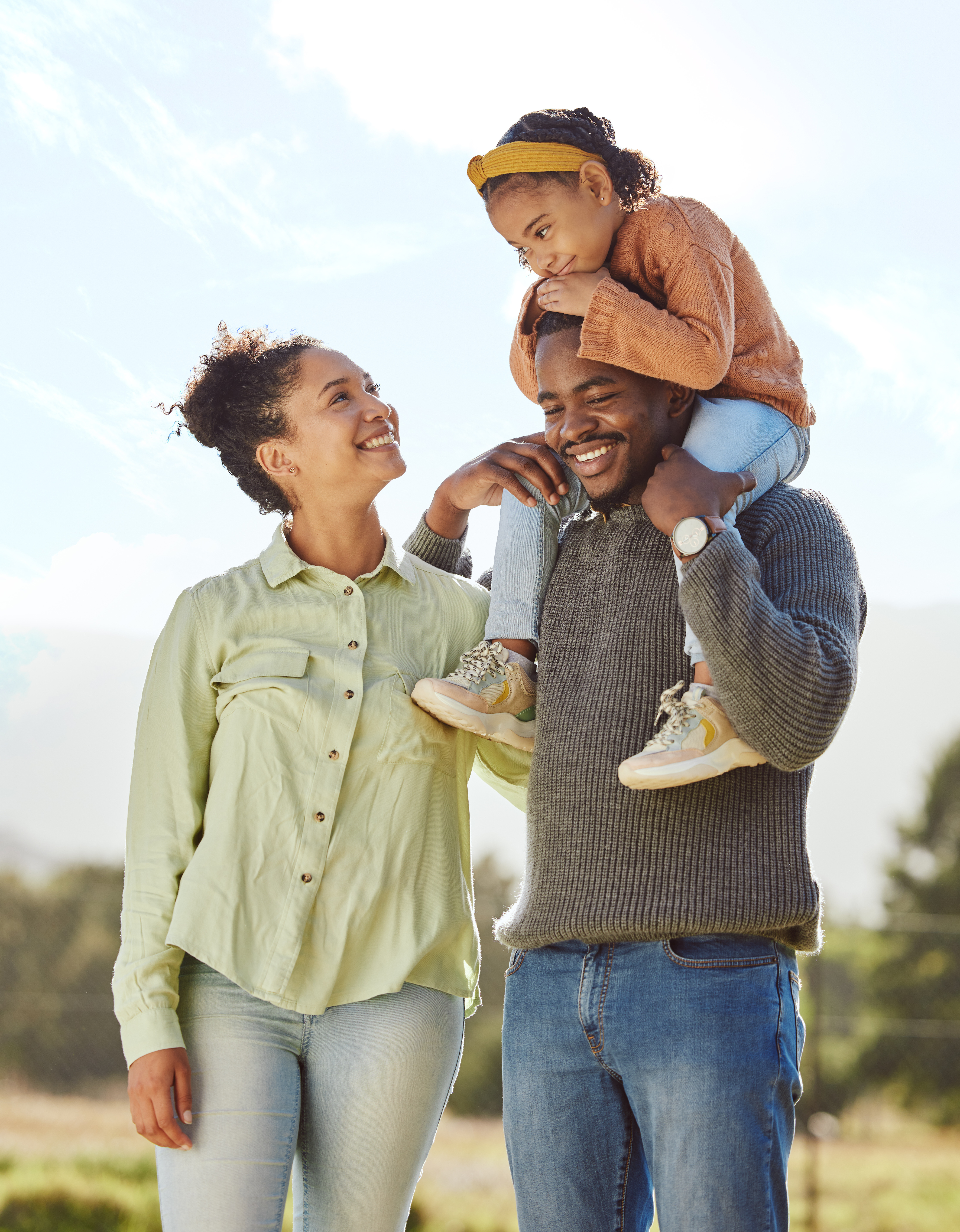 Family of three enjoying time outdoors, symbolizing relief from debt with a consolidation loan.